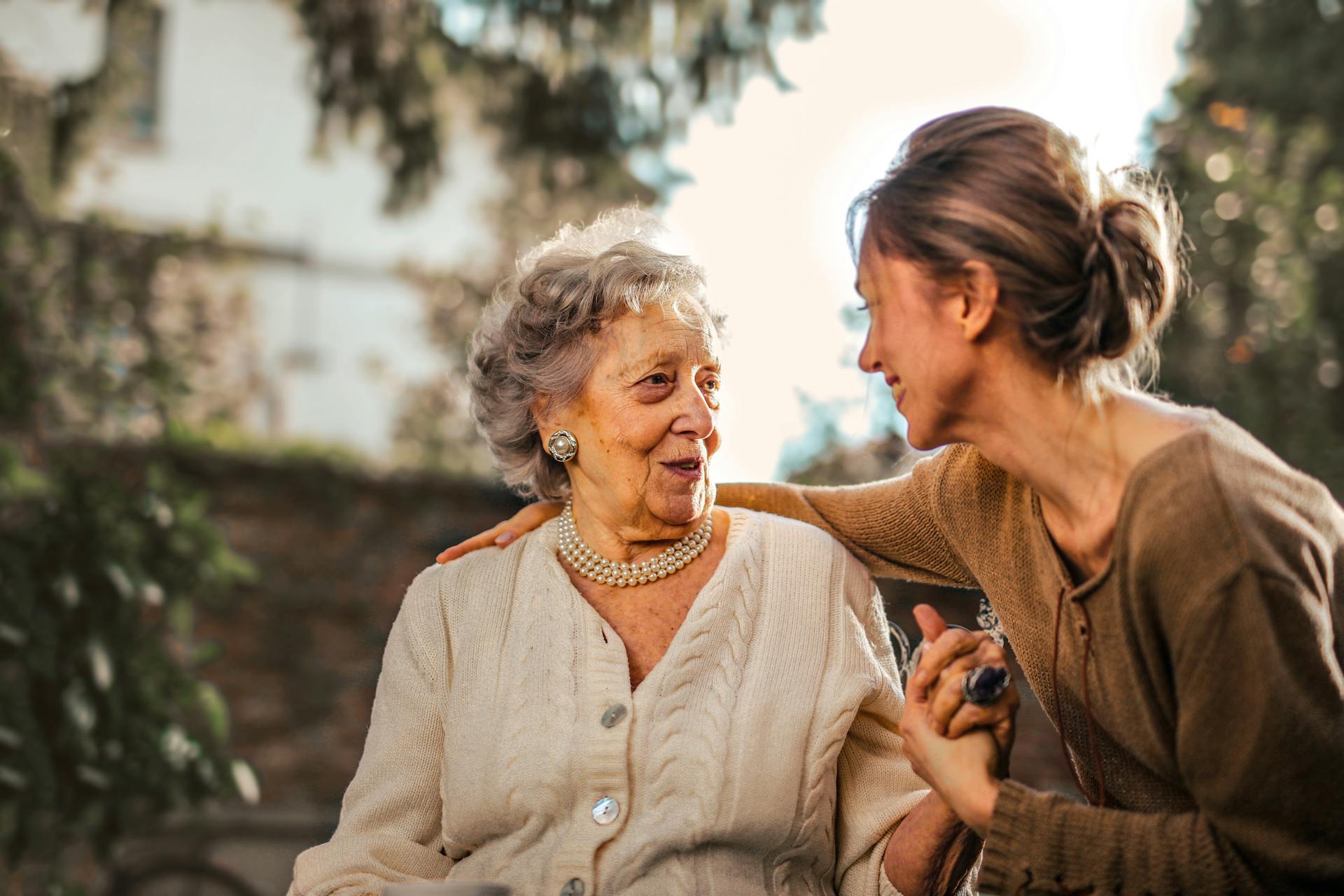 A caregiver and loved one sharing a calm moment together outdoors.